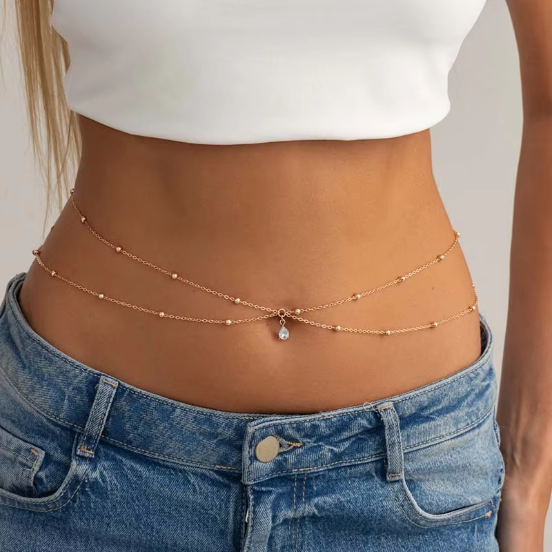 Body Jewelry Gold - 女性用ファッションダブルレイヤービーズウエストチェーン、シンプルなゴールドカラーメタルクロスラウンドビーズボディチェーン、ビキニジュエリーアクセサリー